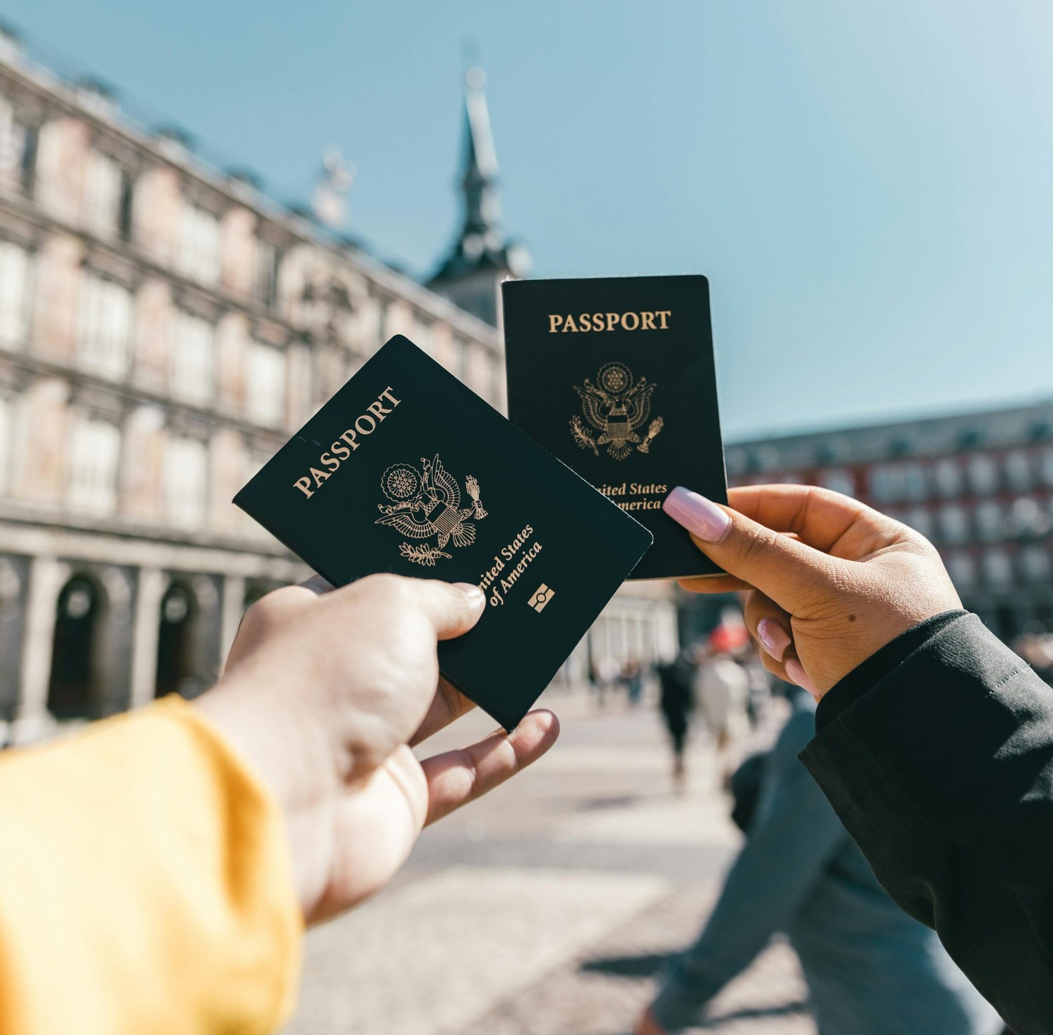 Photo by Spencer Davis: https://www.pexels.com/photo/anonymous-tourists-showing-us-passports-on-street-on-sunny-day-4353813/